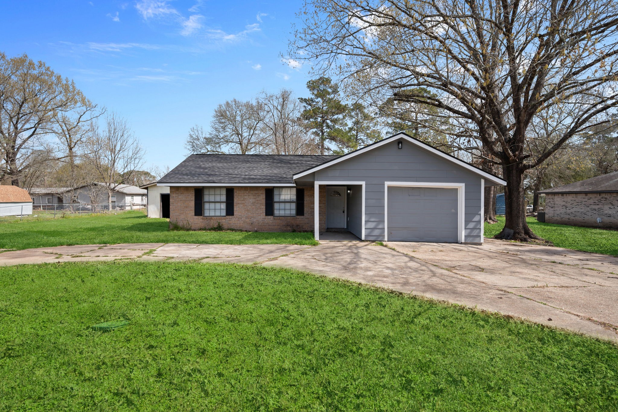 61 Beeson Avenue Shepherd, TX 77371 - Photo 1 of 14 a front view of a house with a garden and yard
