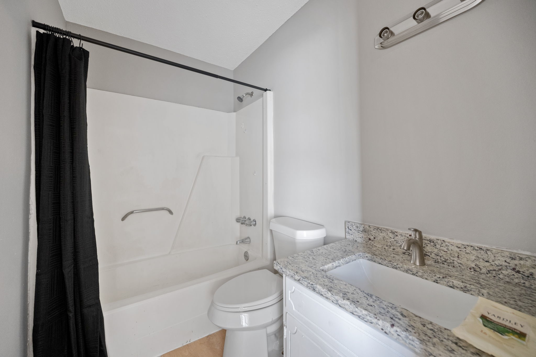 61 Beeson Avenue Shepherd, TX 77371 - Photo 12 of 14 a bathroom with a granite countertop sink toilet and shower