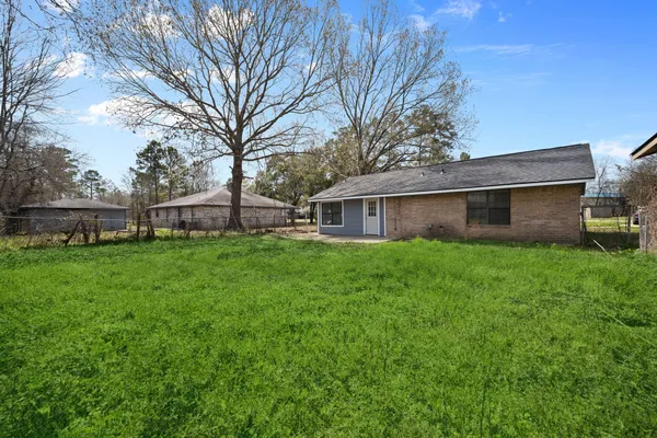 a view of a house with a yard and sitting area