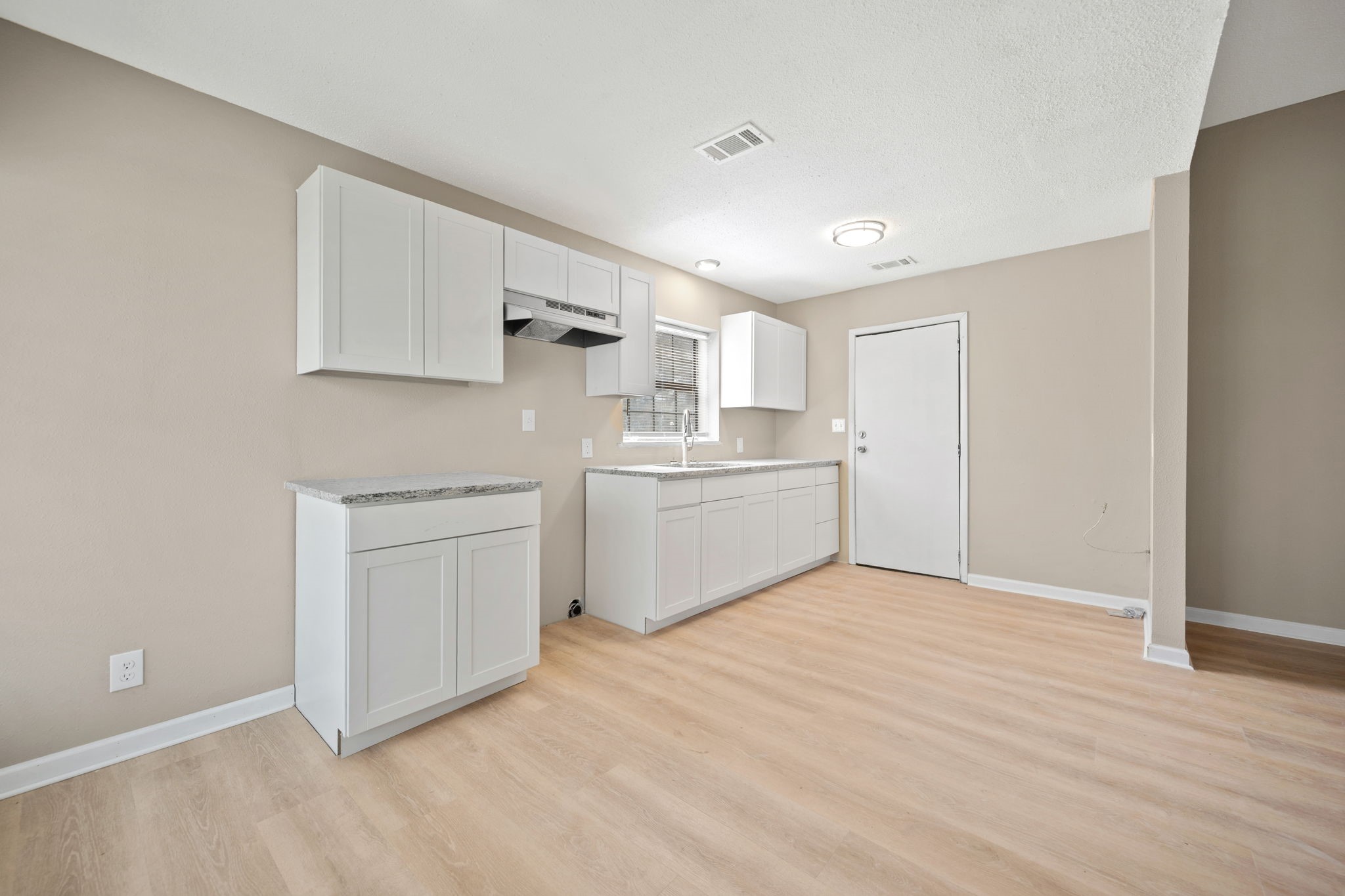 61 Beeson Avenue Shepherd, TX 77371 - Photo 6 of 14 a kitchen with white cabinets and white appliances
