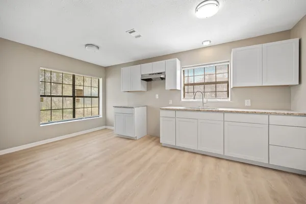 a kitchen with a sink cabinets and window