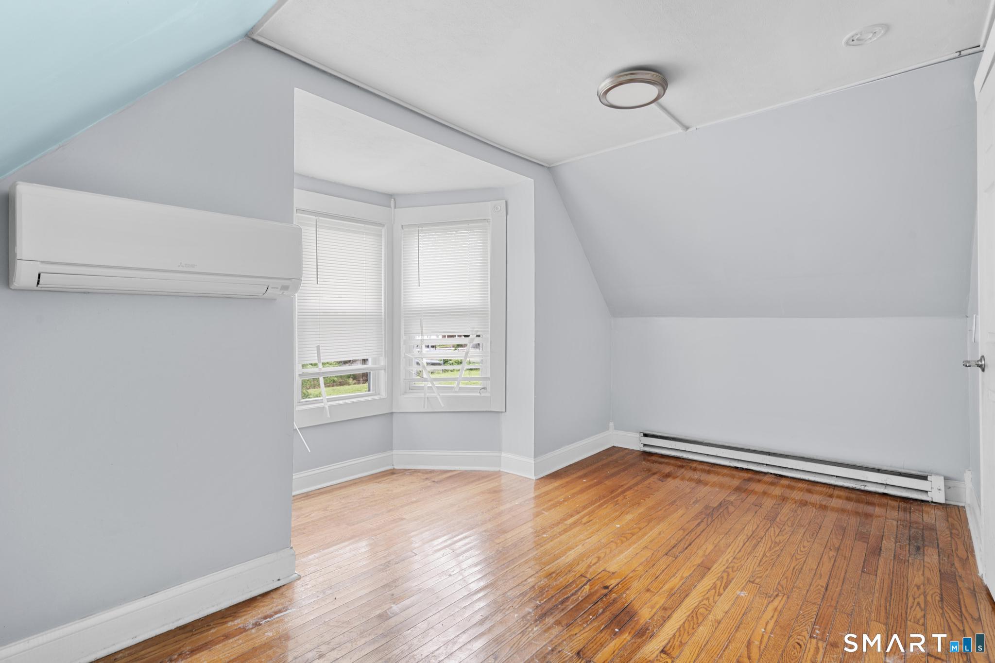 101 Meridian Street Meriden, CT 06451 - Photo 14 of 26 a view of empty room with wooden floor and fan