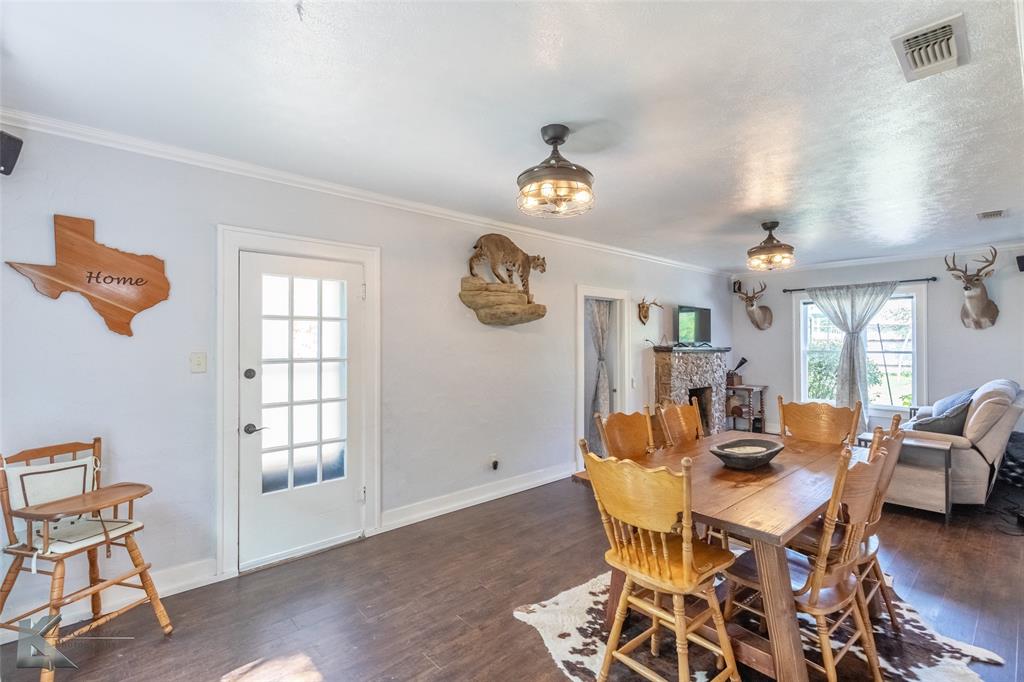 202 East Ross Street Rising Star, TX 76471 - Photo 8 of 40 a view of a dining room with furniture a chandelier and wooden floor