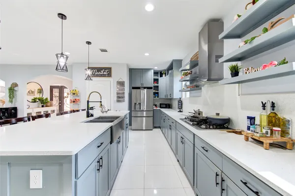 a large white kitchen with lots of counter space and appliances