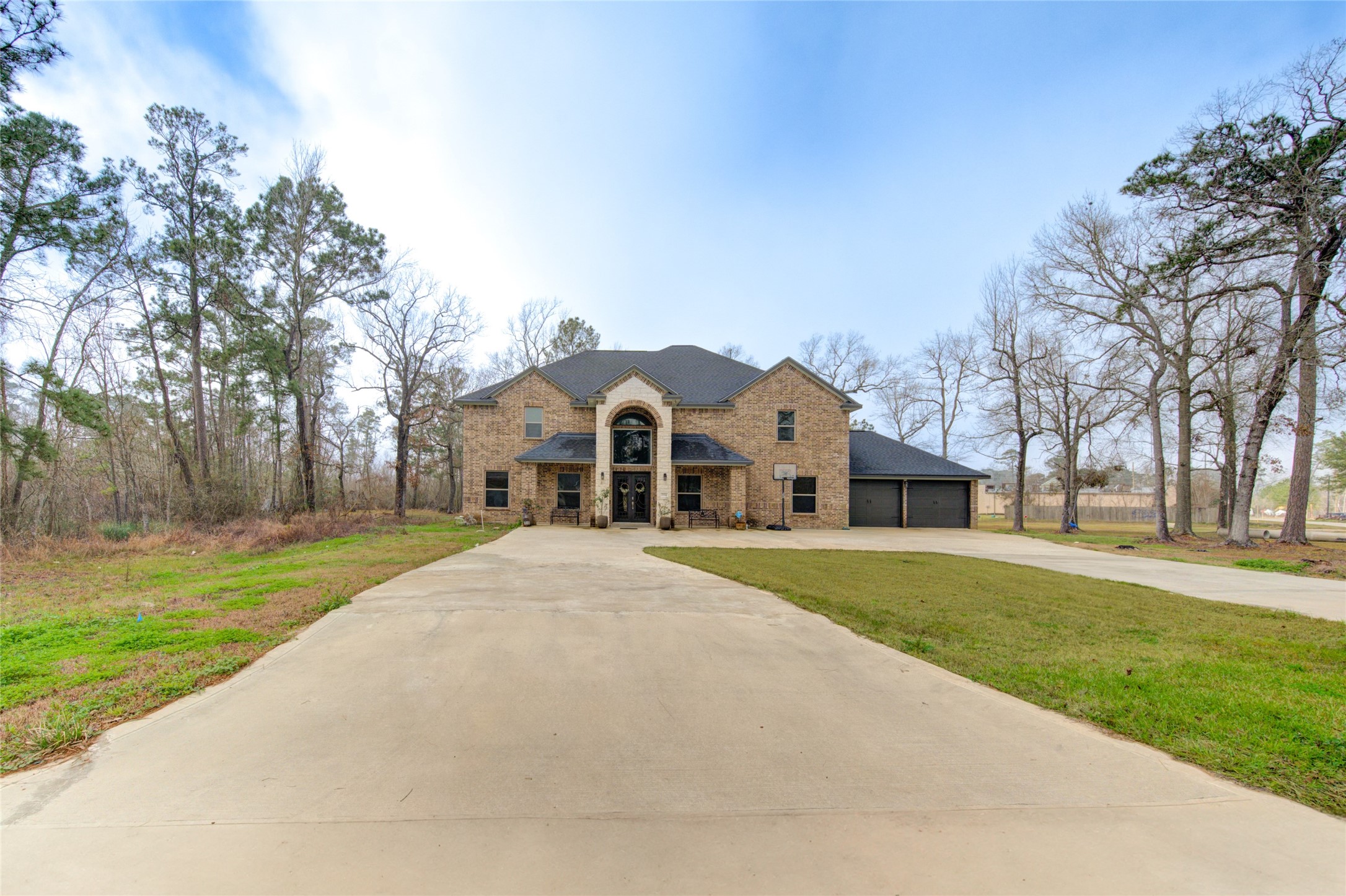 25324 Ravencrest Drive Porter, TX 77365 - Photo 2 of 39 a front view of a house with a yard