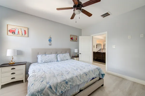 a view of a workspace with furniture and a ceiling fan