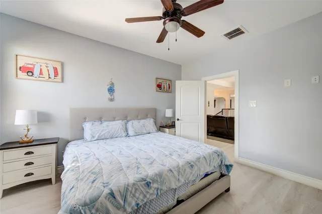 a view of a workspace with furniture and a ceiling fan