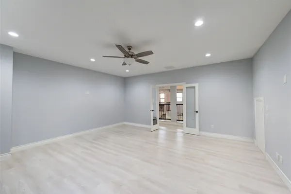 a living room with furniture and a ceiling fan