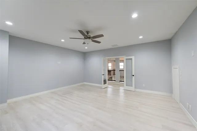 a living room with furniture and a ceiling fan