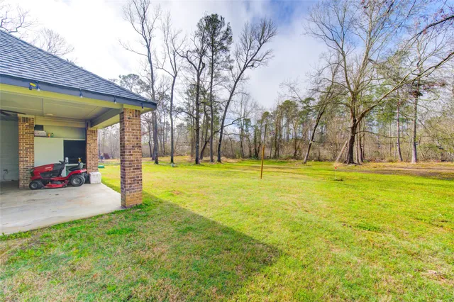 a view of yard with swimming pool and sitting area