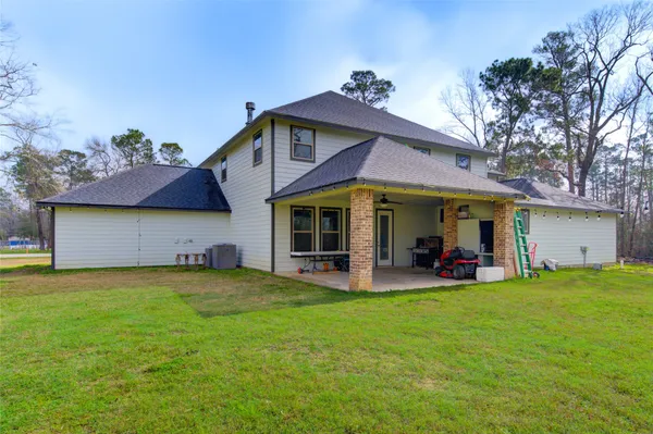 a view of a house with a yard and sitting area