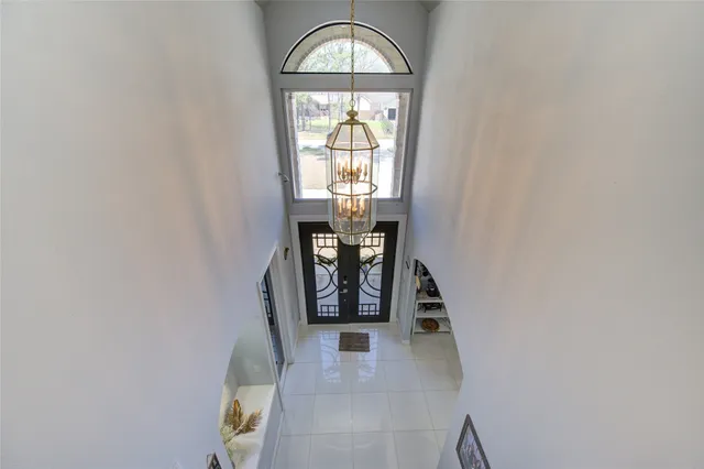 a view of a dining room with furniture and chandelier