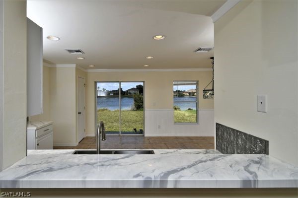 8180 Liriope Loop Lehigh Acres, FL 33972 - Photo 11 of 34 a view of a hallway with wooden floor and windows