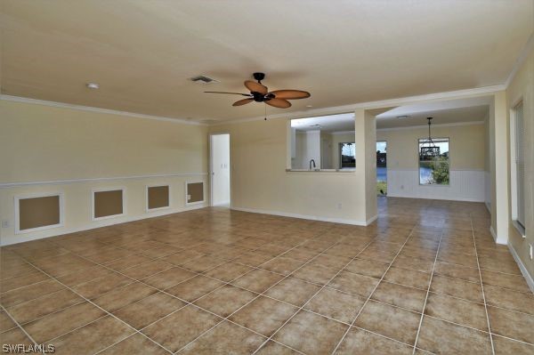 8180 Liriope Loop Lehigh Acres, FL 33972 - Photo 14 of 34 a view of a livingroom with a chandelier fan and windows