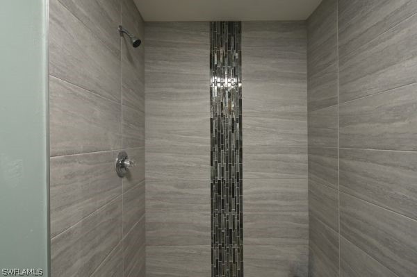 8180 Liriope Loop Lehigh Acres, FL 33972 - Photo 18 of 34 a bathroom with a shower