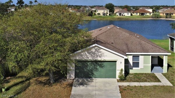 8180 Liriope Loop Lehigh Acres, FL 33972 - Photo 2 of 34 front view of a house with a yard