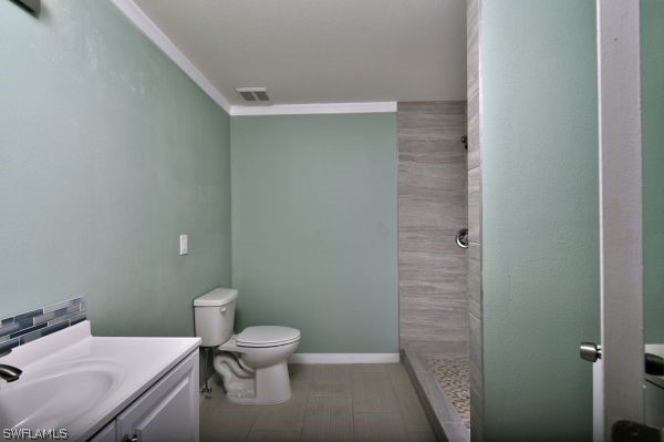 8180 Liriope Loop Lehigh Acres, FL 33972 - Photo 26 of 34 a bathroom with a sink a toilet and a shower