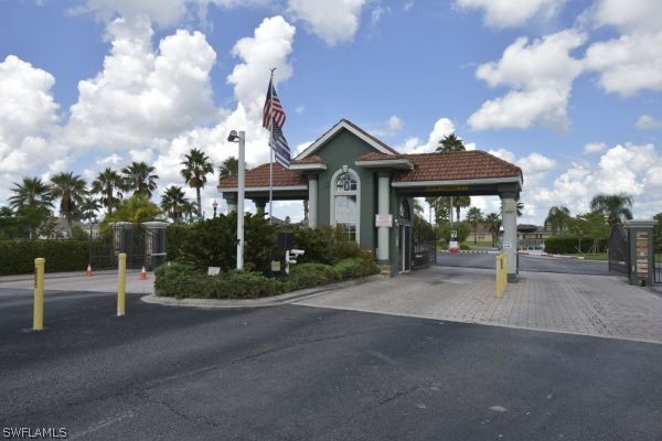 8180 Liriope Loop Lehigh Acres, FL 33972 - Photo 28 of 34 a front view of a house with garden