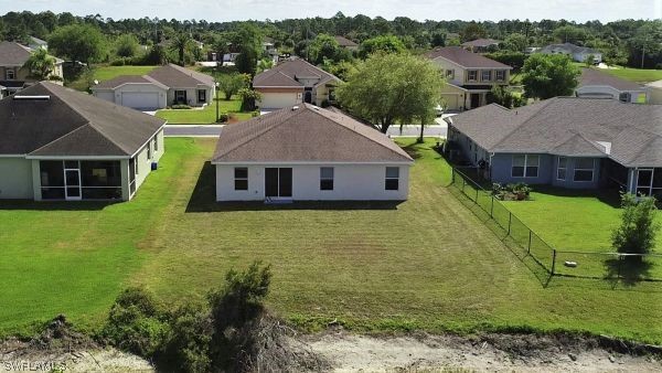 8180 Liriope Loop Lehigh Acres, FL 33972 - Photo 30 of 34 a aerial view of a house with a big yard