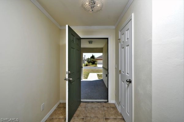 8180 Liriope Loop Lehigh Acres, FL 33972 - Photo 6 of 34 a view of a hallway with wooden floor and a bathroom