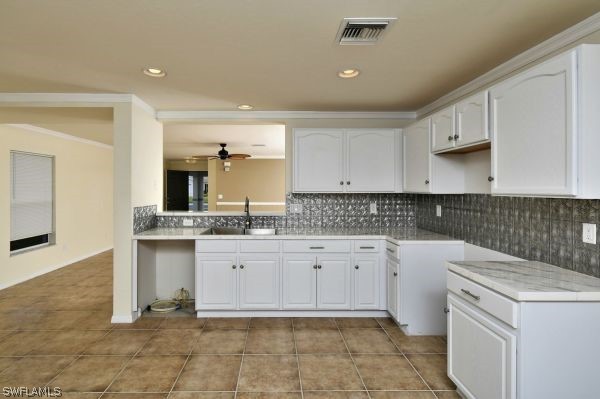 8180 Liriope Loop Lehigh Acres, FL 33972 - Photo 9 of 34 a kitchen with granite countertop white cabinets white stainless steel appliances with a sink and dishwasher