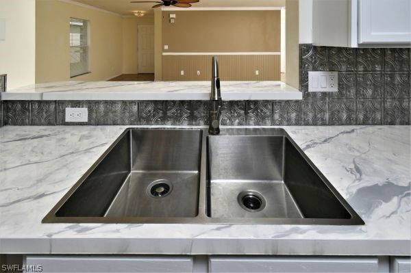 8180 Liriope Loop Lehigh Acres, FL 33972 - Photo 10 of 34 a bathroom with a granite countertop sink a mirror and bathtub