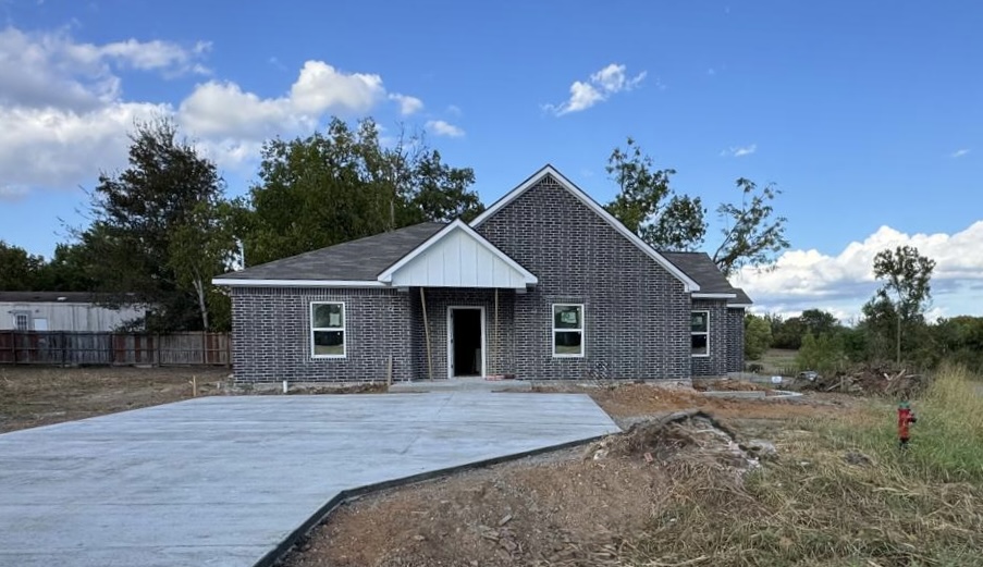 602 7th Street Navasota, TX 77868 - Photo 4 of 4 a front view of house with yard and trees in the background