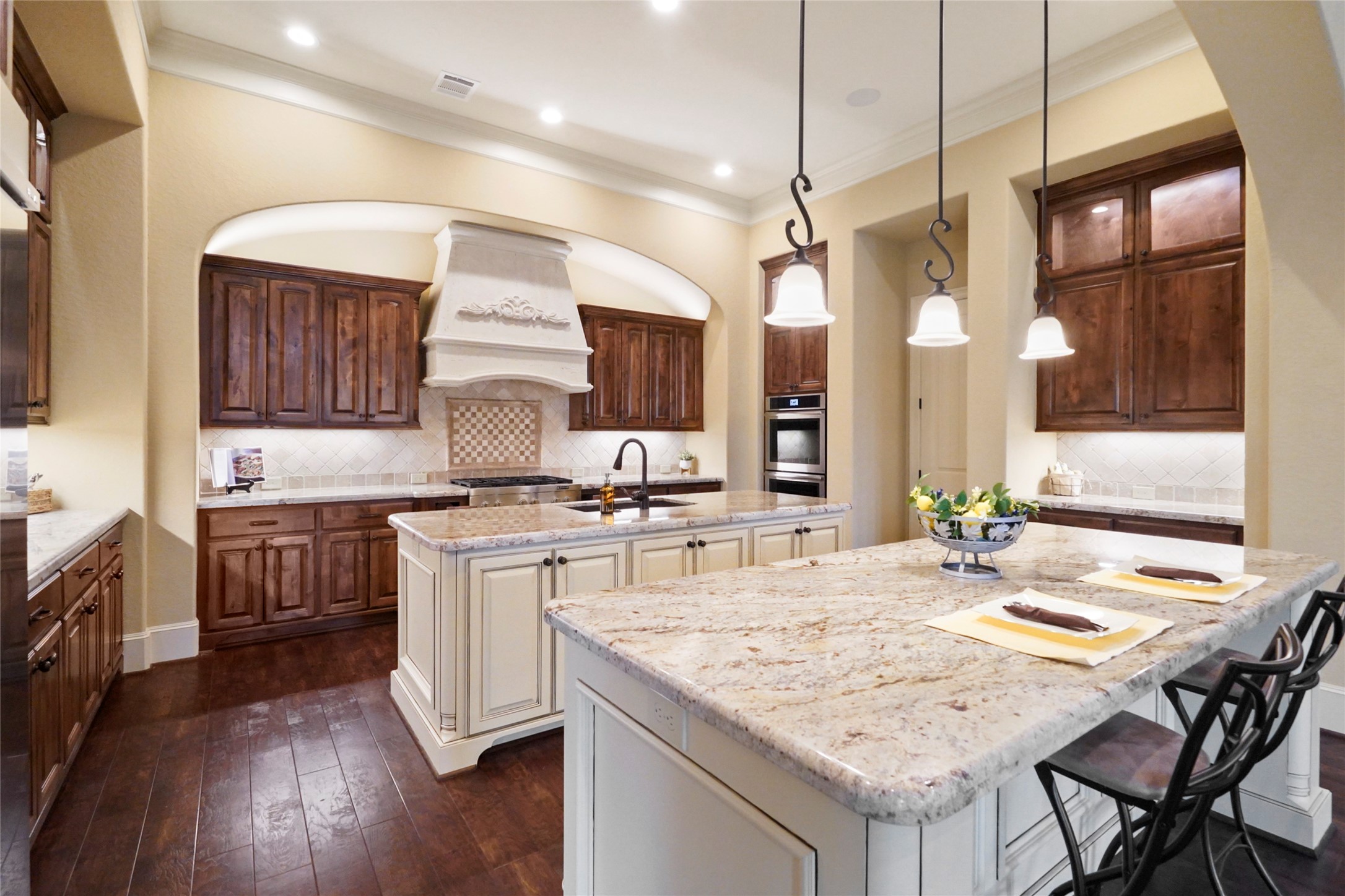 18 Rugged Lark Circle Tomball, TX 77377 - Photo 12 of 50 Gourmet Kitchen -Heart of the Home- LED floodlights- Pendant lighting- Under cabinet lights - Lighted Glass door upper cabinets and feature lights throughout.