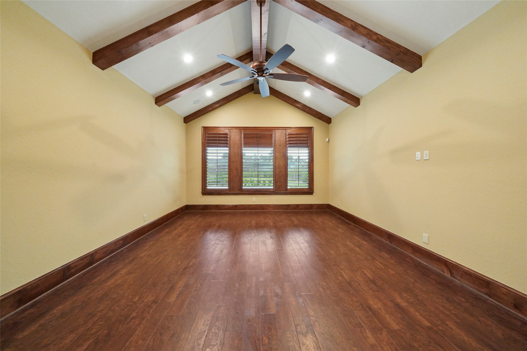 18 Rugged Lark Circle Tomball, TX 77377 - Photo 32 of 50 Primary suite with high vaulted wood beam ceiling. Plantation shutters - patio access and bedside Lutron lighting controls.
