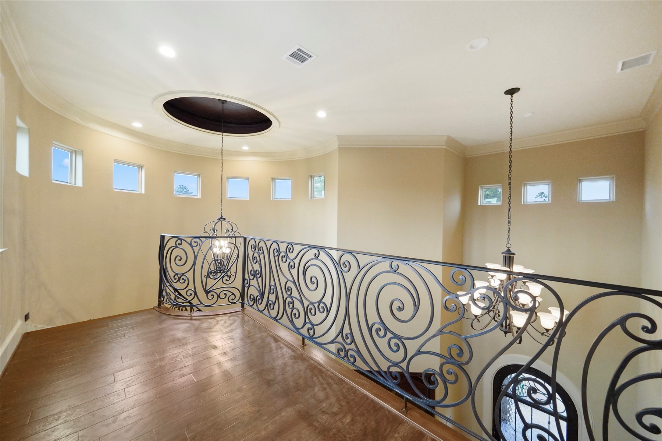 18 Rugged Lark Circle Tomball, TX 77377 - Photo 34 of 50 Magnificent view from the upper Landing. You can see all the detail in the iron work. Small windows strategically placed for maximizing the natural light.