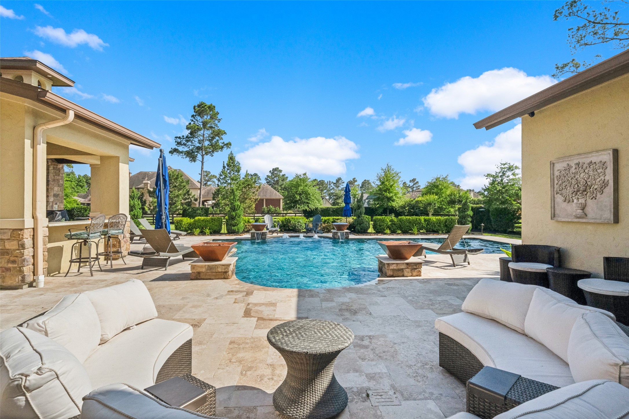 18 Rugged Lark Circle Tomball, TX 77377 - Photo 45 of 50 Another large space ideal for additional seating, games, or more tables if necessary. Host the ultimate party for friends and family to enjoy! Seating space at the outdoor kitchen - pool complete with water features & fire bowls!