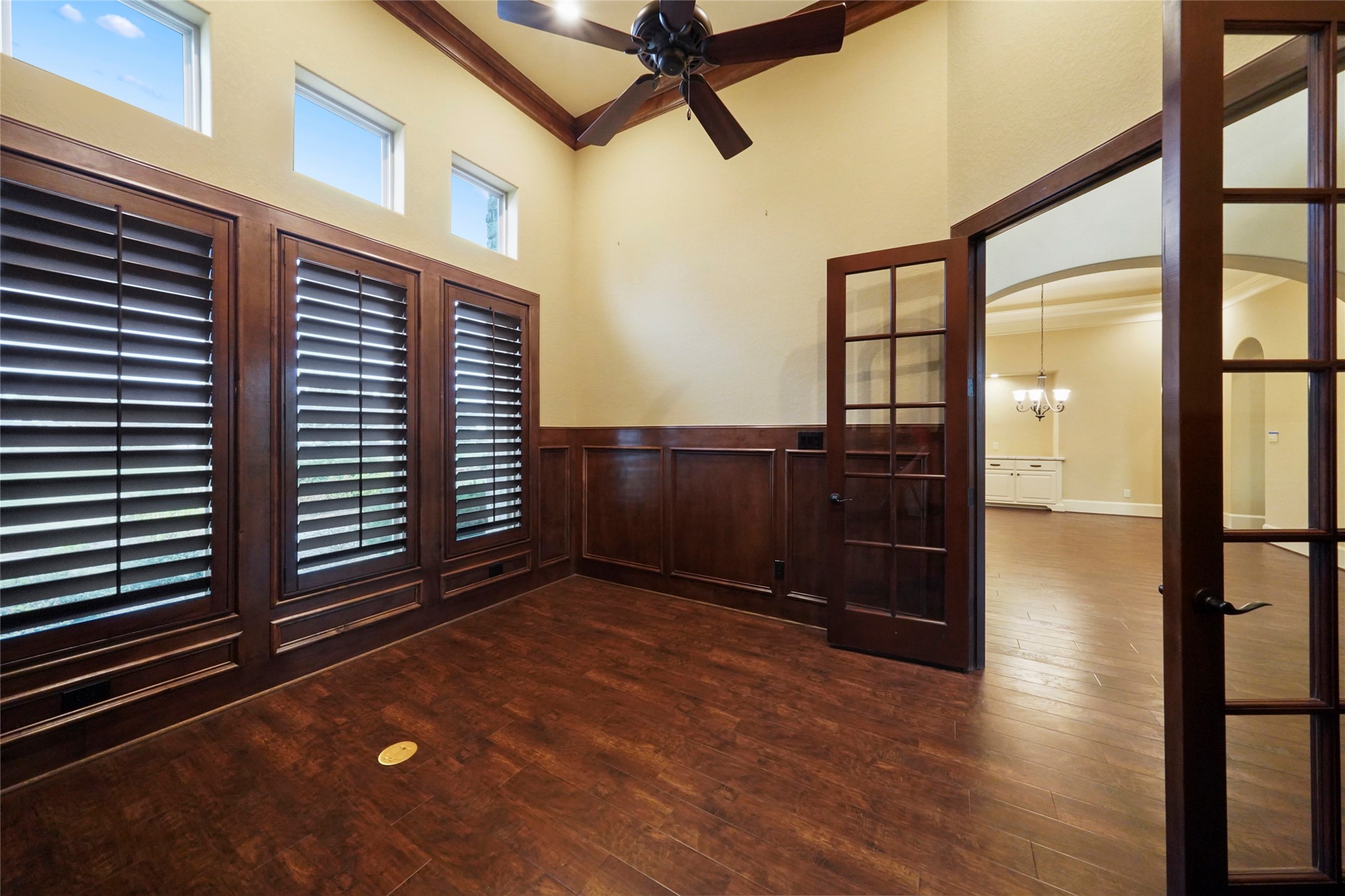 18 Rugged Lark Circle Tomball, TX 77377 - Photo 7 of 50 French Doors open into this Executive study/office. Natural lights windows, wooden plantation shutters and rich wood all around.
