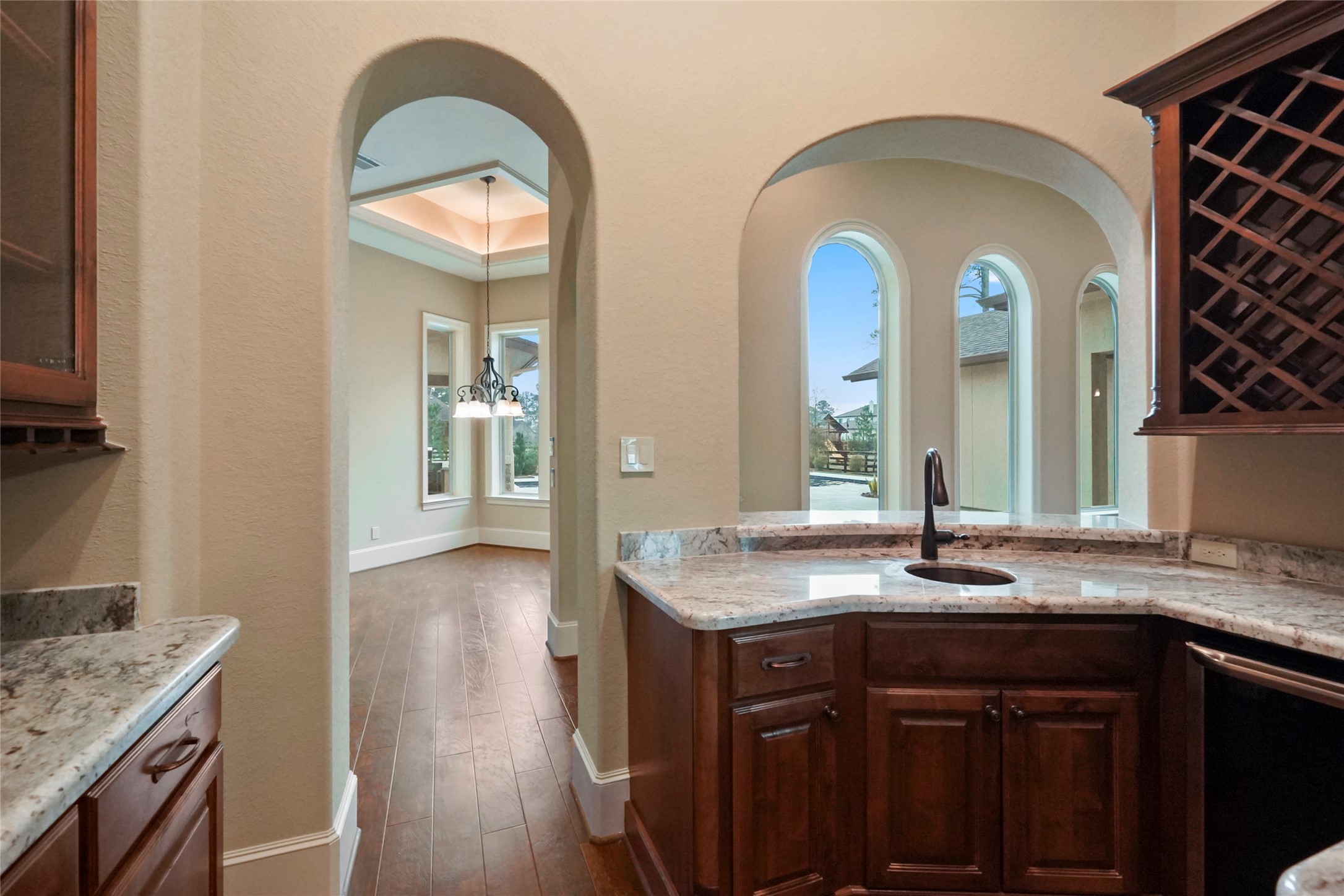 18 Rugged Lark Circle Tomball, TX 77377 - Photo 10 of 50 Bar niche features sink, wine refrigerator, built in Wine Racks, Built in Stemware holders, granite countertops and glass display shelves.