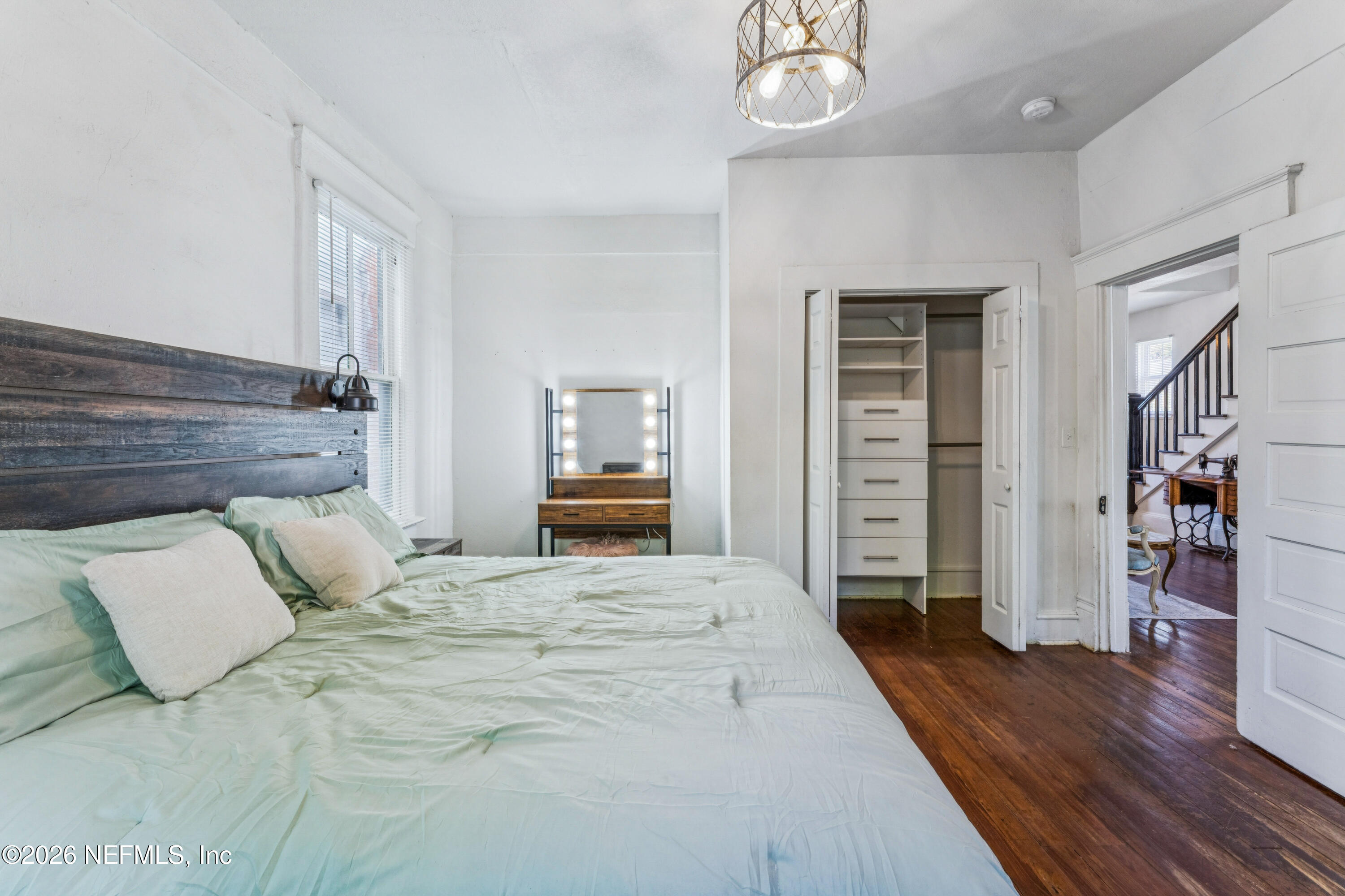 1625 Perry Street Jacksonville, FL 32206 - Photo 13 of 36 a bedroom with a large bed and a wooden floor