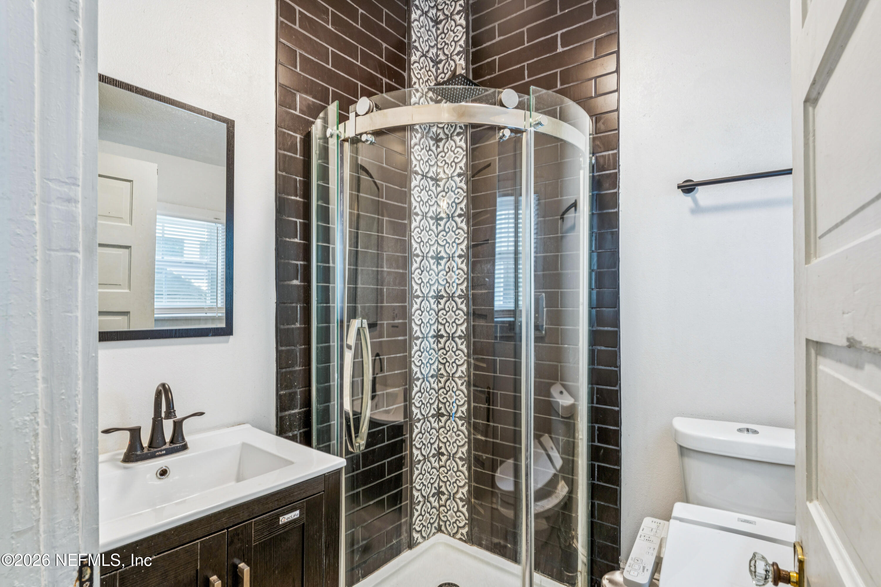 1625 Perry Street Jacksonville, FL 32206 - Photo 14 of 36 a bathroom with a shower a sink and a mirror