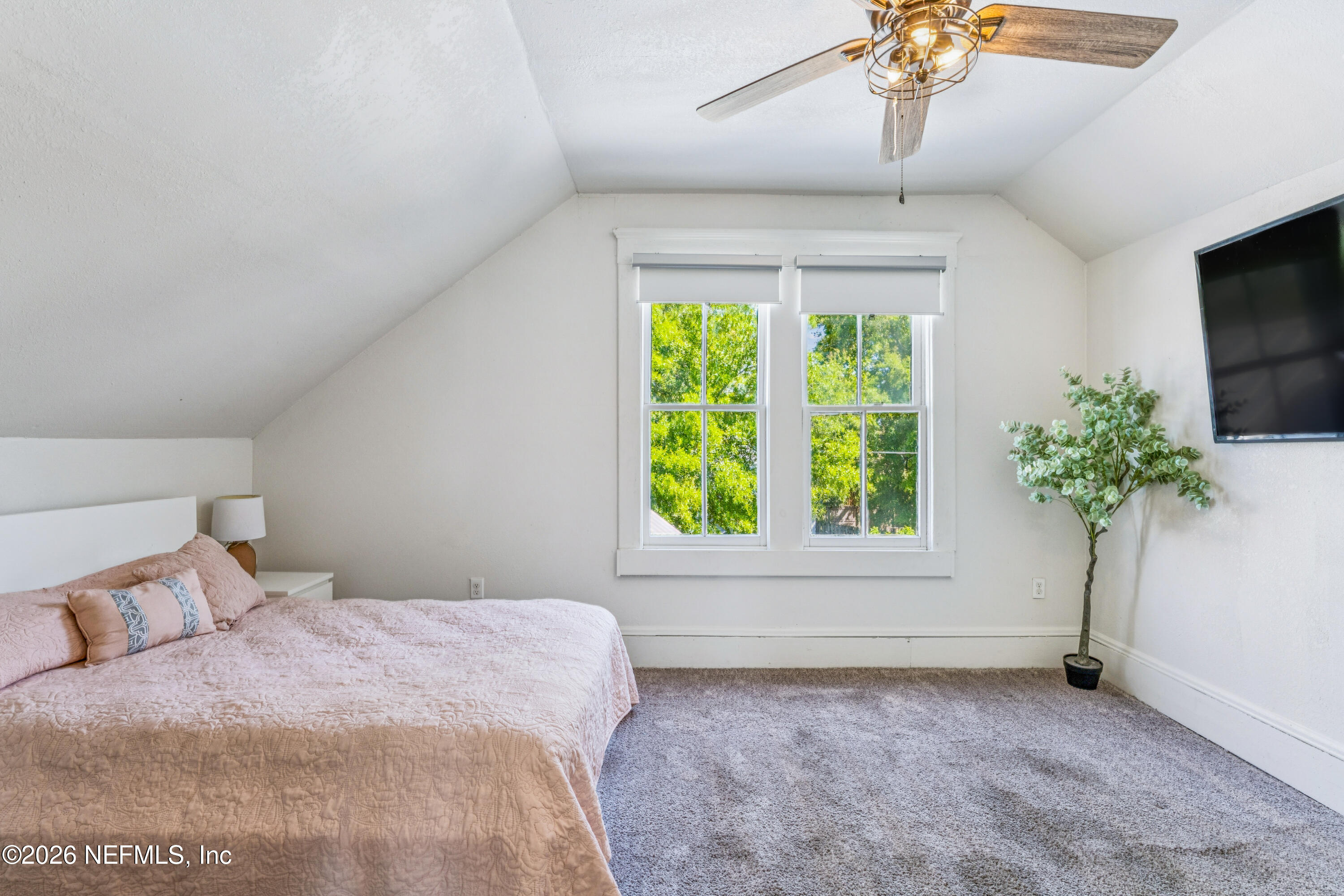 1625 Perry Street Jacksonville, FL 32206 - Photo 19 of 36 a bedroom with a bed and a potted plant