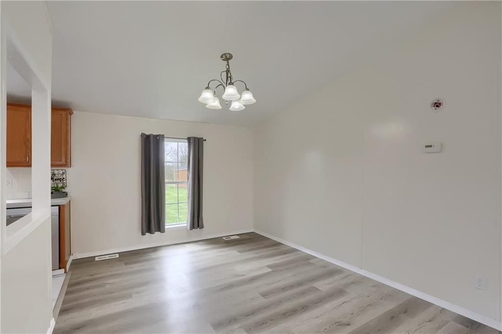 140 McCaslin Road New Castle, PA 16101 - Photo 11 of 28 an empty room with wooden floor and windows