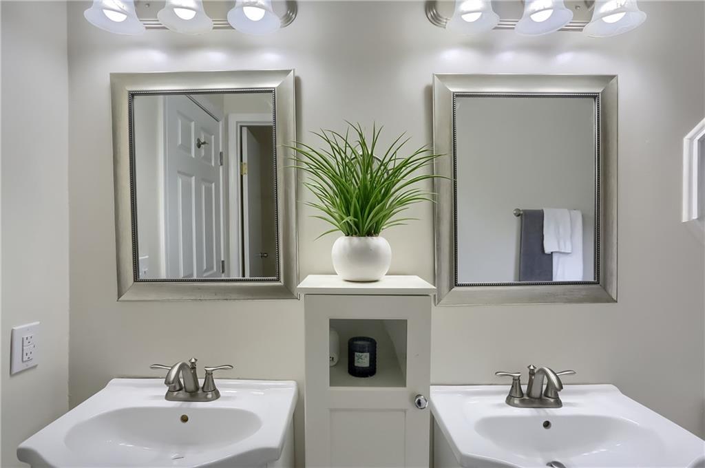 140 McCaslin Road New Castle, PA 16101 - Photo 16 of 28 a bathroom with a sink a mirror and a potted plant