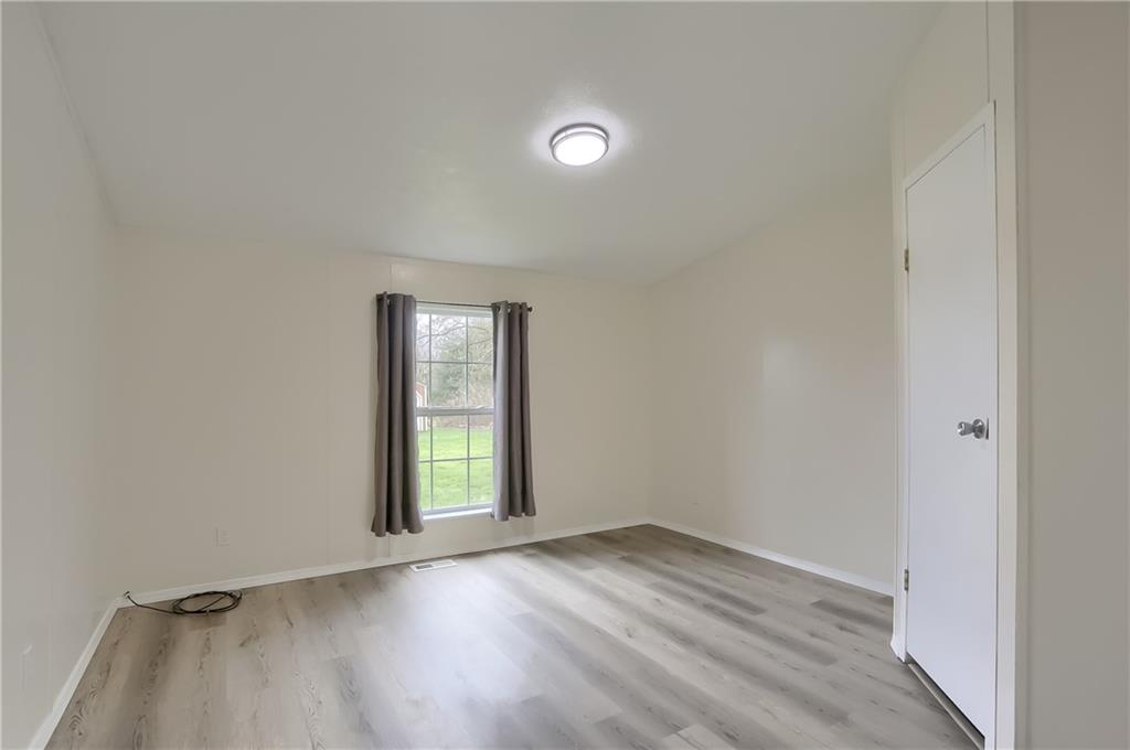 140 McCaslin Road New Castle, PA 16101 - Photo 22 of 28 an empty room with wooden floor and windows