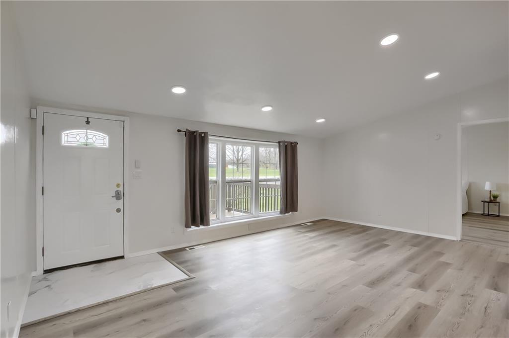 140 McCaslin Road New Castle, PA 16101 - Photo 5 of 28 a view of an empty room with wooden floor and a window