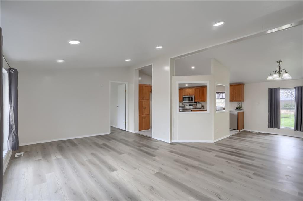 140 McCaslin Road New Castle, PA 16101 - Photo 6 of 28 wooden floor in an empty room with a kitchen