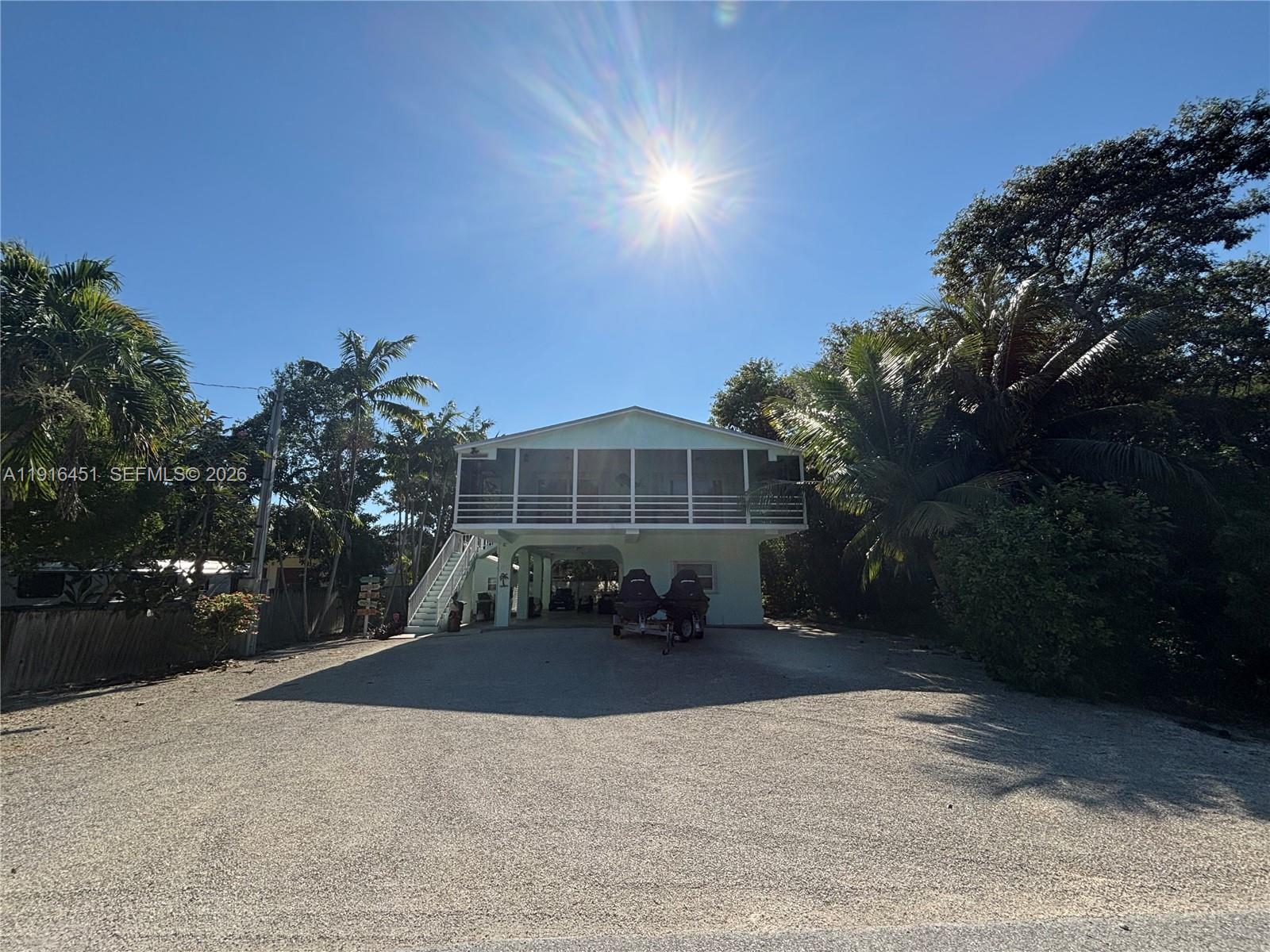 63 Bass Avenue, Unit 2 Key Largo, FL 33037 - Photo 2 of 24 a front view of a house with a yard