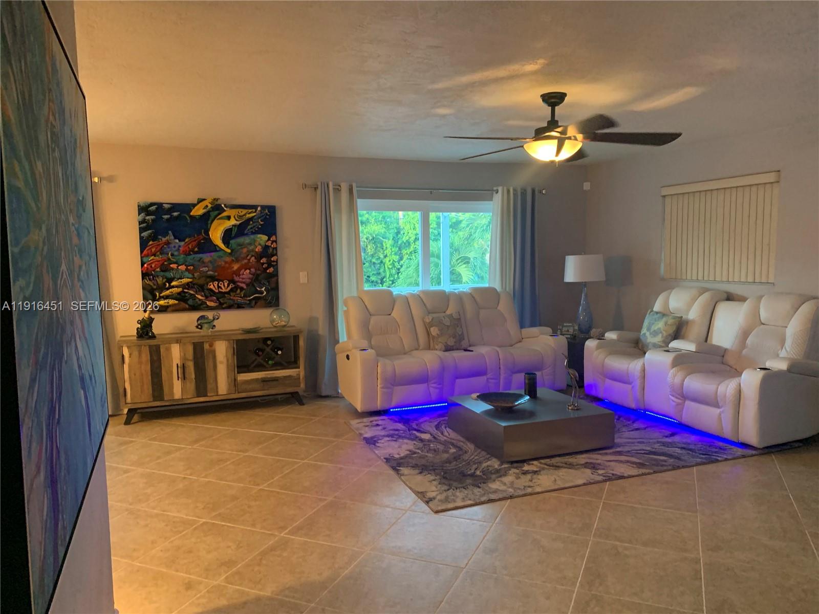 63 Bass Avenue, Unit 2 Key Largo, FL 33037 - Photo 5 of 24 a living room with furniture and a flat screen tv