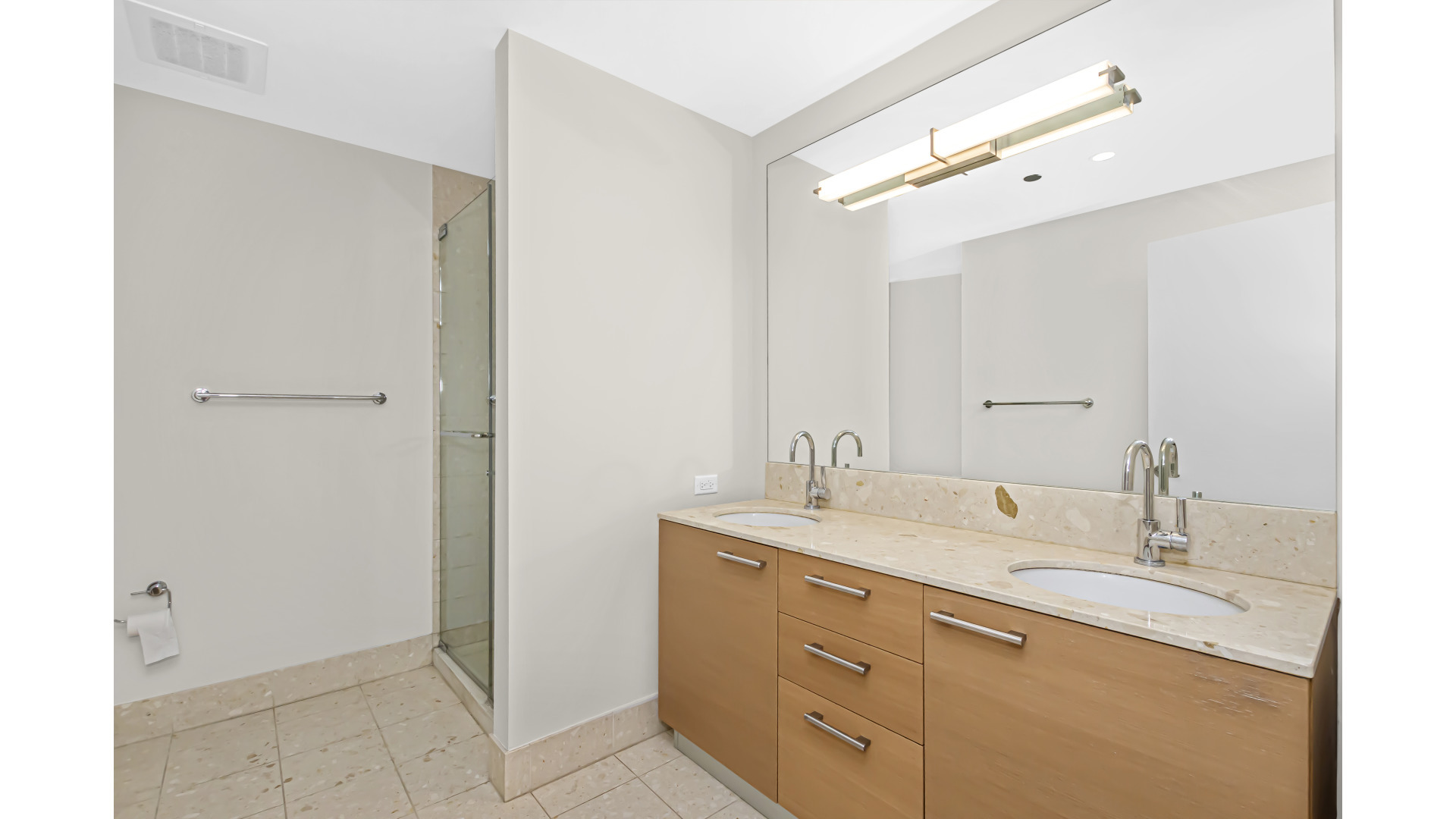 340 East Randolph Street, Unit 404 Chicago, IL 60601 - Photo 12 of 20 a bathroom with a granite countertop sink and a mirror