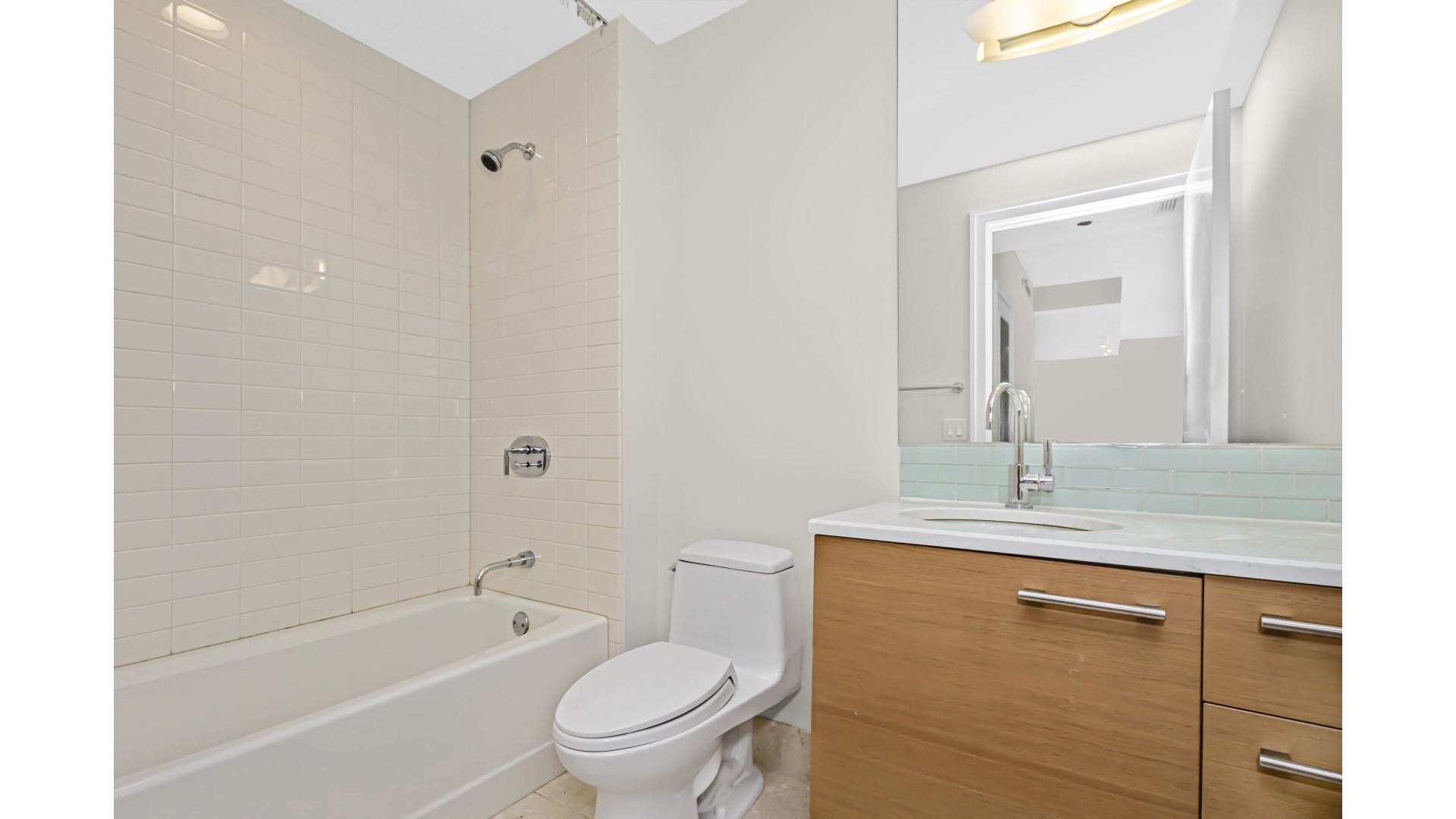 340 East Randolph Street, Unit 404 Chicago, IL 60601 - Photo 13 of 20 a bathroom with a granite countertop sink toilet and shower