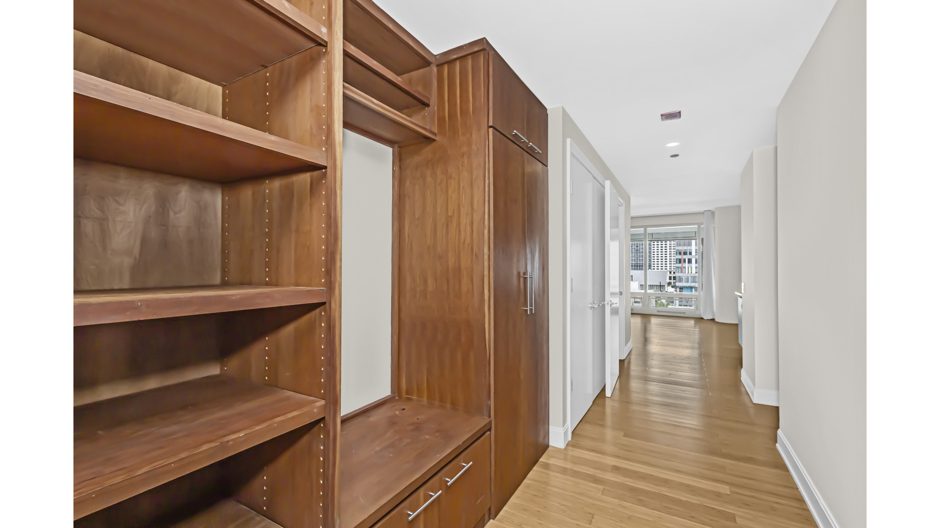 340 East Randolph Street, Unit 404 Chicago, IL 60601 - Photo 2 of 20 a view of a hallway with wooden floor and staircase