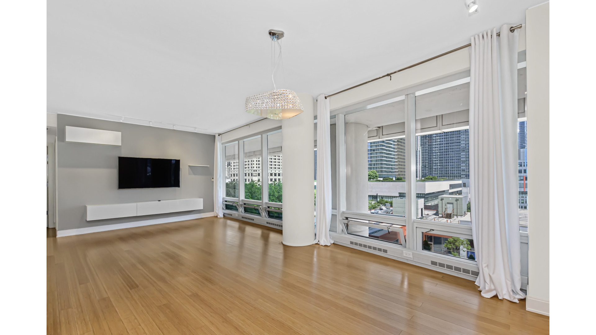 340 East Randolph Street, Unit 404 Chicago, IL 60601 - Photo 5 of 20 a living room with furniture and a flat screen tv