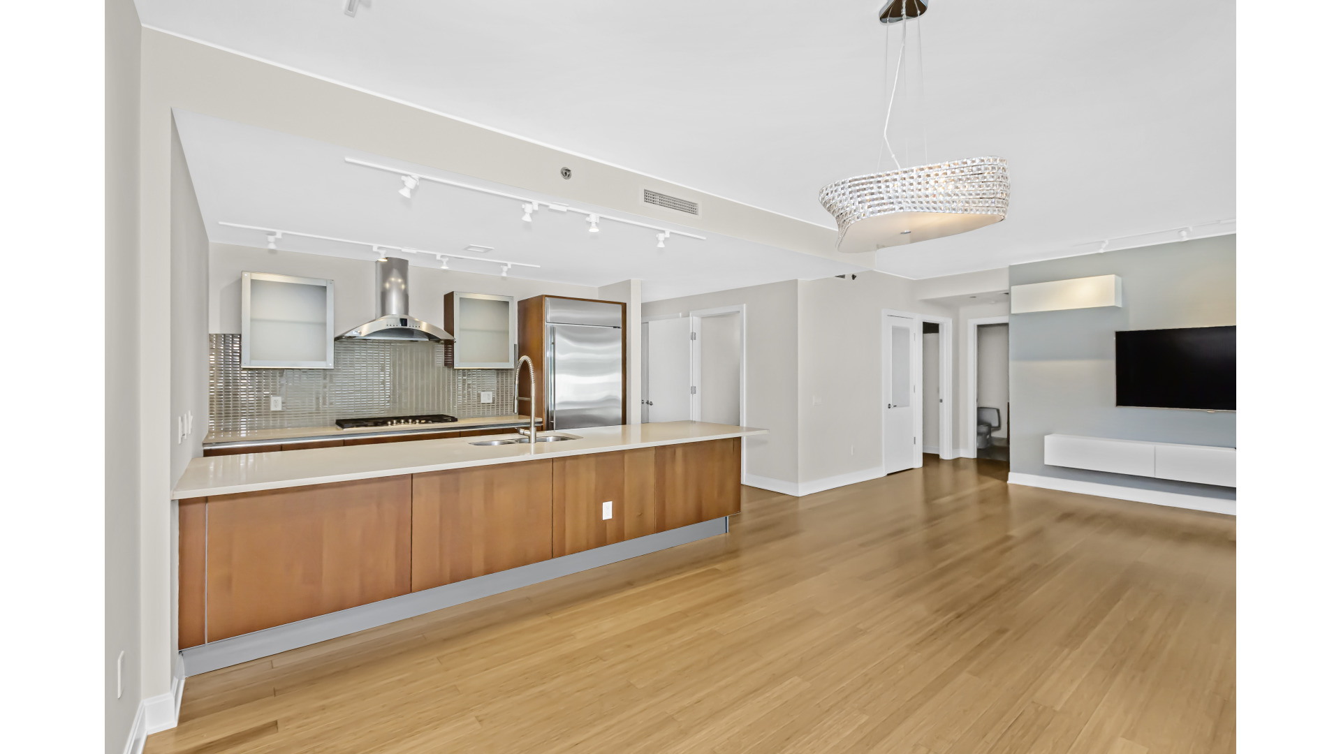 340 East Randolph Street, Unit 404 Chicago, IL 60601 - Photo 7 of 20 a large kitchen with kitchen island a sink stainless steel appliances and cabinets