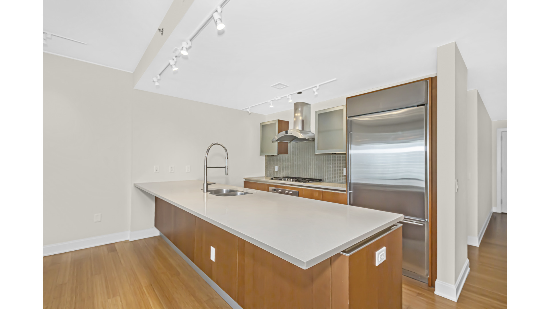 340 East Randolph Street, Unit 404 Chicago, IL 60601 - Photo 8 of 20 a kitchen that has a sink a stove and a refrigerator