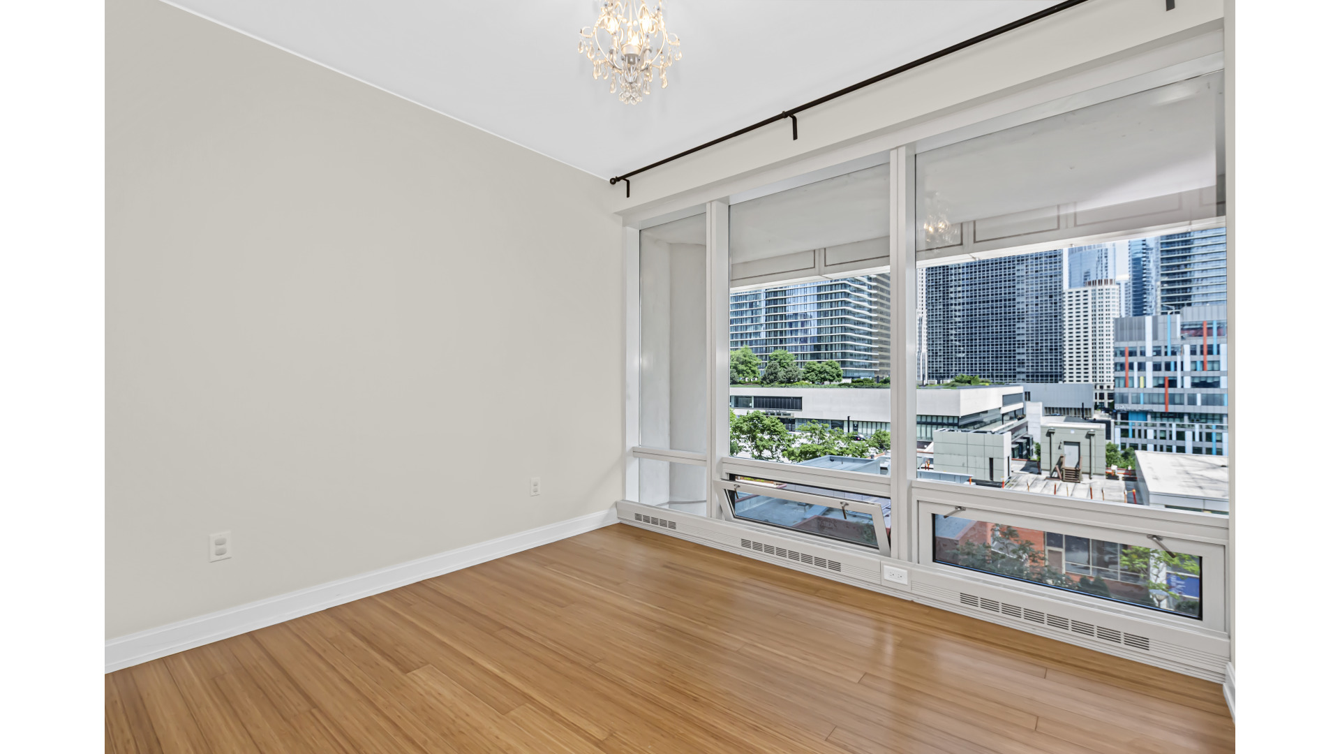 340 East Randolph Street, Unit 404 Chicago, IL 60601 - Photo 10 of 20 a room with natural light and hardwood floor